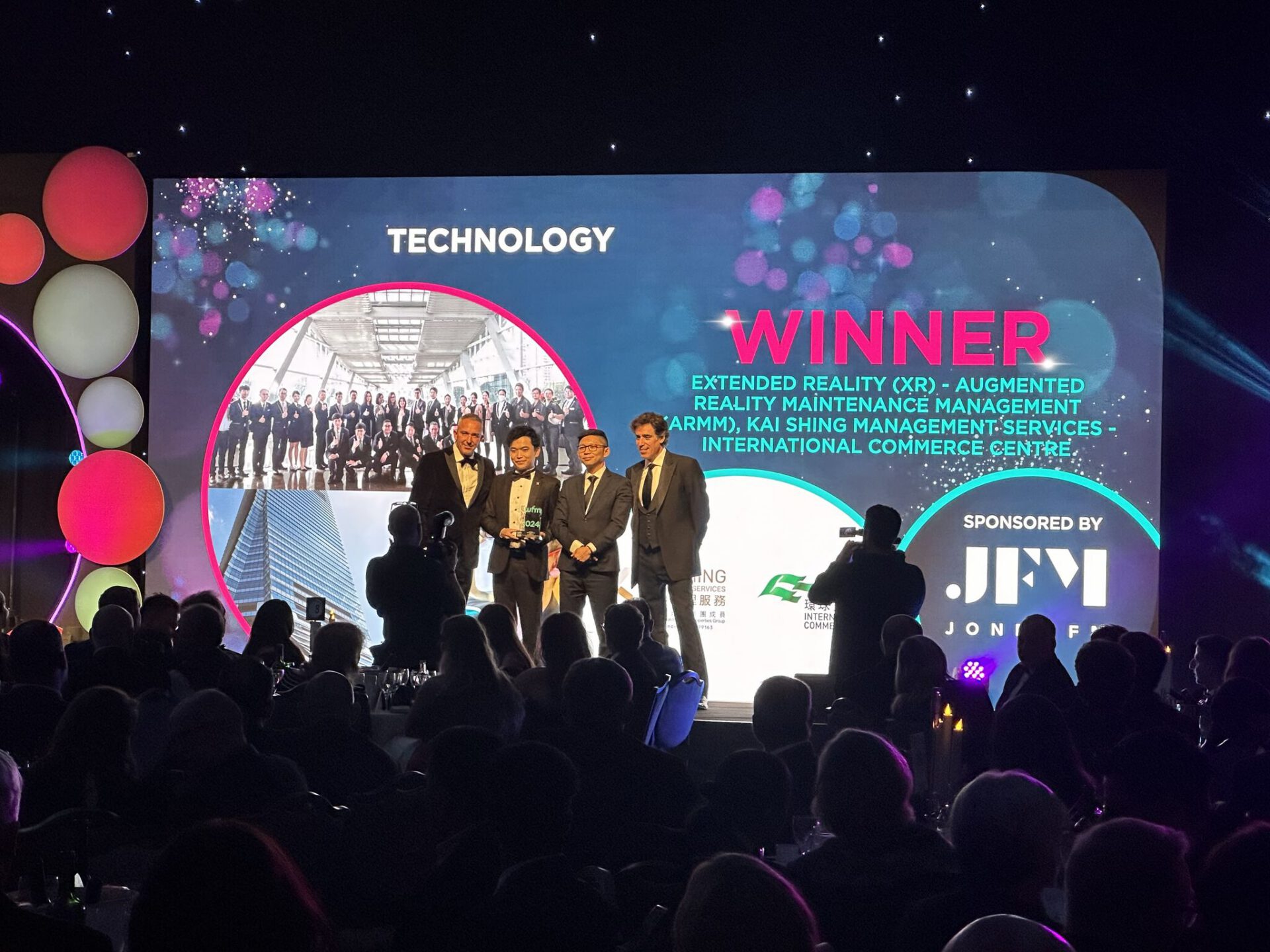 Kai Shing Management Services receiving the IWFM Impact Awards 2024 Technology Award on stage.